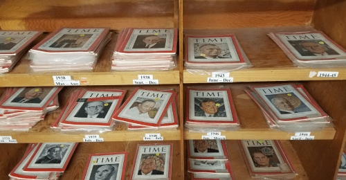 A wooden shelf displaying various issues of Time magazine from 1938 to 1942, featuring different covers.