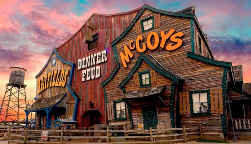 A rustic building with "Hatfields" and "McCoys" signs, set against a colorful sunset sky.