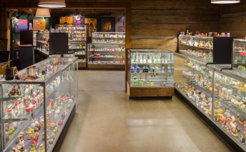 A display room filled with glass cases showcasing a variety of colorful collectibles and figurines.