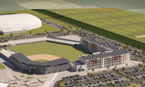 Aerial view of a sports complex featuring a baseball field, soccer fields, and a multi-story building.