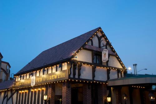 A charming pub and brewery with a rustic facade, adorned with string lights, under a twilight sky.