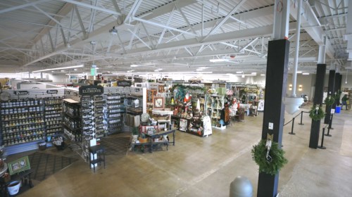 A spacious retail store filled with various home decor items and seasonal decorations, featuring organized shelves and displays.