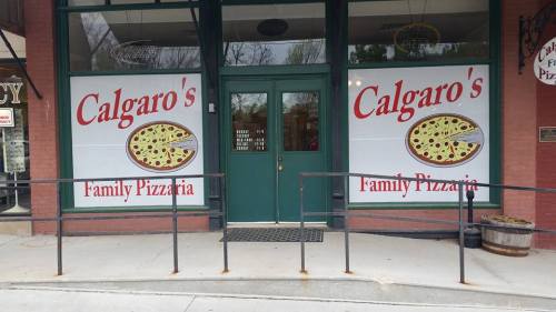 Exterior of Calgaro's Family Pizzeria, featuring large signs with a pizza graphic and welcoming entrance.