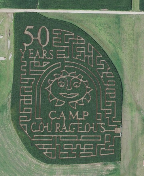 Aerial view of a corn maze celebrating 50 years of Camp Courageous, featuring a sun and the camp's name.