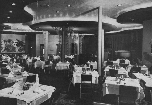 Elegant restaurant interior with neatly set tables, soft lighting, and a stylish decor.