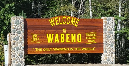 Welcome sign for Wabeno, established in 1897, highlighting its status as a historic logging town.
