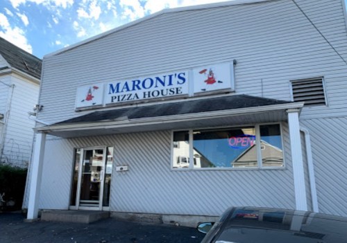 Exterior of Maroni's Pizza House, featuring a sign and an "OPEN" neon light in the window.