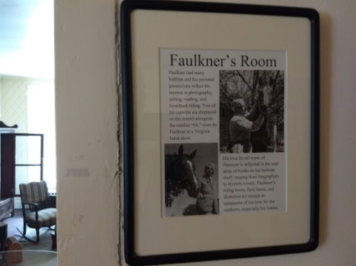 Framed article titled "Faulkner's Room" discussing Faulkner's hobbies and personal possessions related to photography and horses.