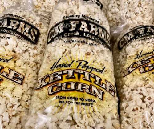 A bag of hand-popped kettle corn from CM Farms, featuring the brand name and "Growing Memories" tagline.