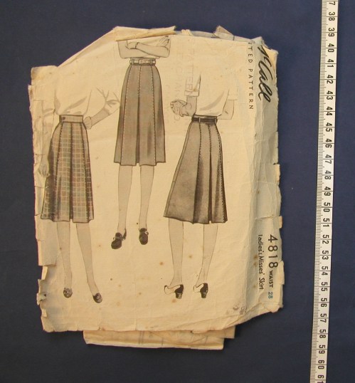 Vintage sewing pattern for skirts, featuring three designs with illustrations and measurements on a worn paper background.