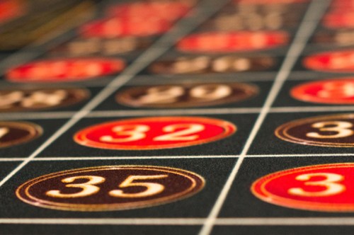 Close-up of a roulette table showing red and black numbered pockets, with focus on numbers 32 and 35.