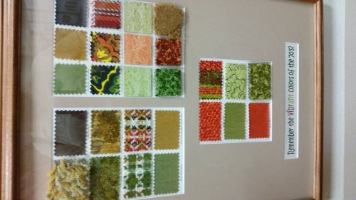 A framed display of colorful fabric swatches in various patterns and textures, labeled "Remember the Vibrant Colors of the 70s."