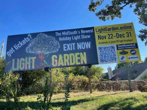 Billboard advertising the "Light Garden" holiday light show, with dates and a QR code for tickets.