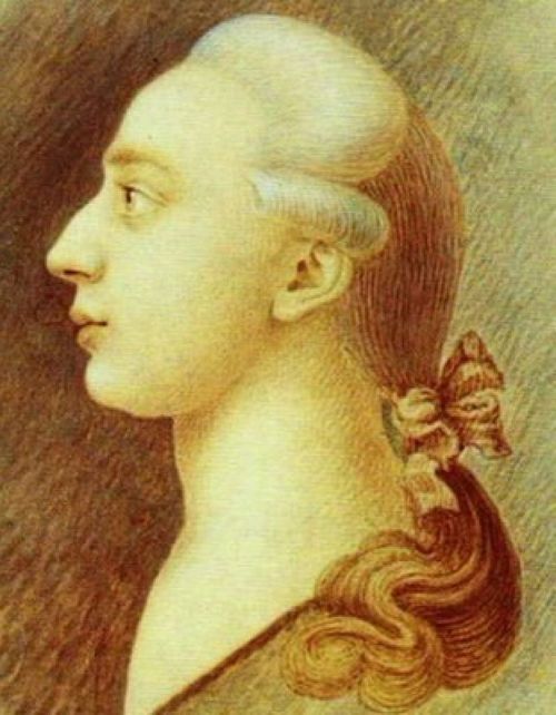Profile portrait of a young man with light hair tied back, featuring a delicate bow and soft facial features.