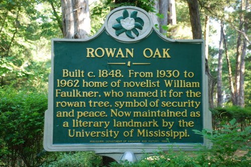 Sign for Rowan Oak, home of novelist William Faulkner, highlighting its historical significance and connection to the University of Mississippi.