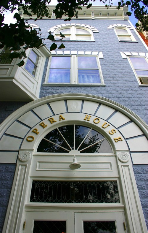 A close-up of the entrance to an ornate building labeled "Opera House," featuring decorative architectural details.