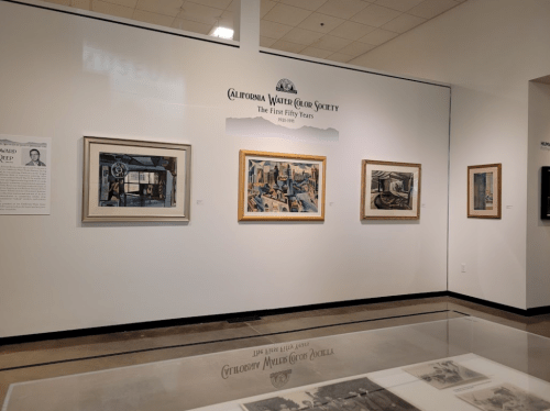 Gallery wall featuring framed artworks from the California Water Color Society's first fifty years.