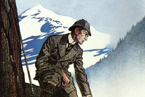 A man in a suit and hat crouches on a rocky ledge, gazing into a misty valley with mountains in the background.