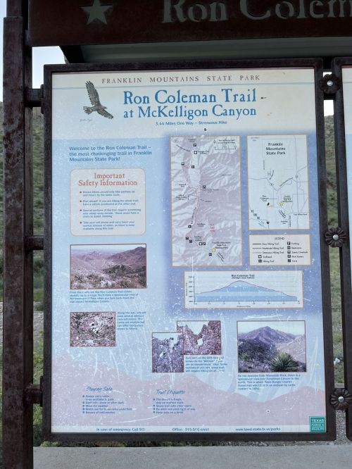 Sign for Ron Coleman Trail at McKelligon Canyon, featuring park information, trail map, and safety guidelines.