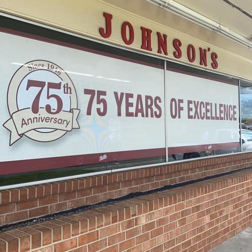 Sign celebrating Johnson's 75th anniversary, highlighting "75 Years of Excellence" since 1948.
