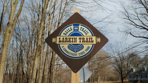 Sign for Larkin Trail, a Connecticut State Park, featuring a blue and gold design on a brown background.