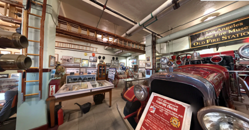 Interior of a fire museum featuring vintage fire trucks, historical photos, and firefighting memorabilia.