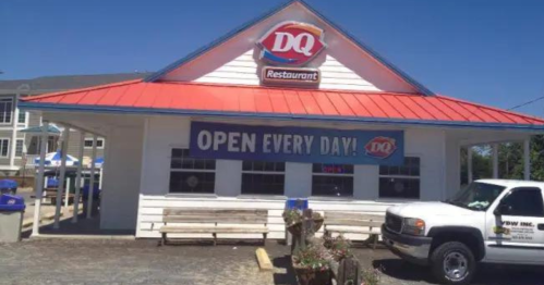 A Dairy Queen restaurant with a red roof and a sign saying "Open Every Day!" on a sunny day.