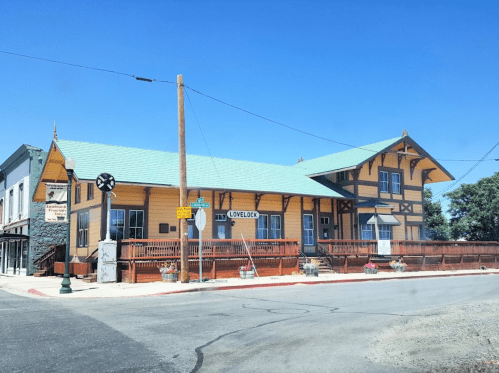 Historic building in Lovelock, featuring a colorful facade and a green roof, set against a clear blue sky.