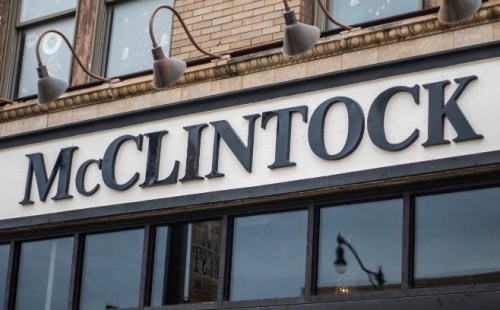 Sign for "McClintock" displayed on a building exterior, featuring large black letters against a white background.