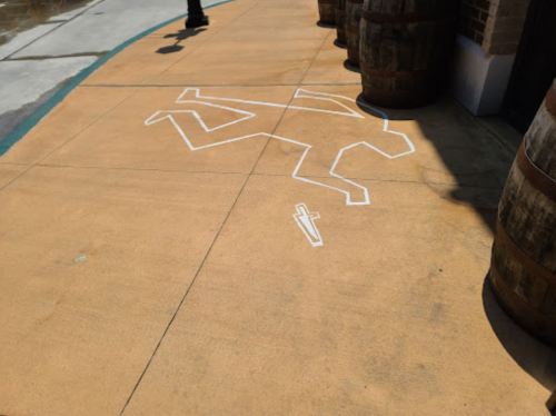 Chalk outline of a body on a sidewalk, with a knife illustration nearby, next to wooden barrels.