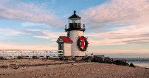 Sunset photo of the Nantucket Lighthouse with a Christmas wreath on the side
