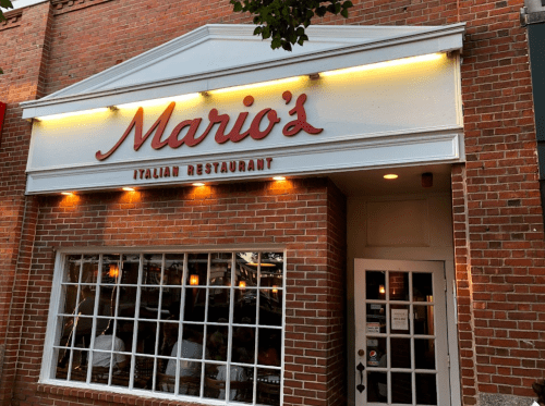 Exterior of Mario's Italian Restaurant, featuring a brick facade and large windows with a welcoming entrance.