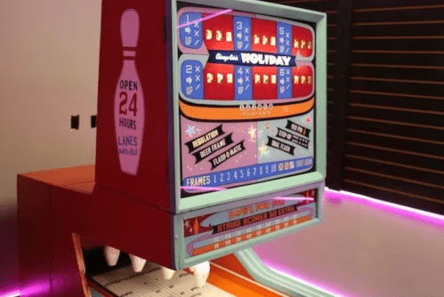 A colorful bowling-themed arcade game with a digital score display and neon lighting.