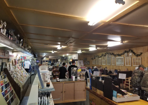 A cozy interior of a rustic store or café, with shelves, tables, and patrons enjoying their time.