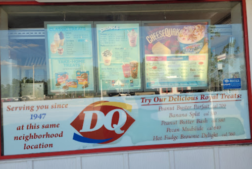 Menu display at a DQ location featuring treats, drinks, and special items, with a "Serving you since 1947" sign.