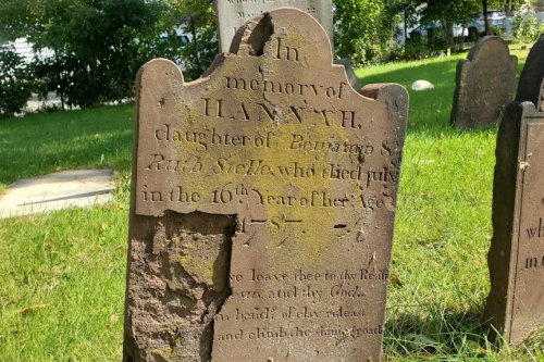 Weathered gravestone with inscriptions honoring Hannah, daughter of Benjamin S. and Ruth Stelle, who died at age 16.