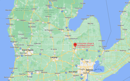 Map of Michigan highlighting Crossroads Village & Huckleberry Railroad location near Flint, with nearby cities marked.