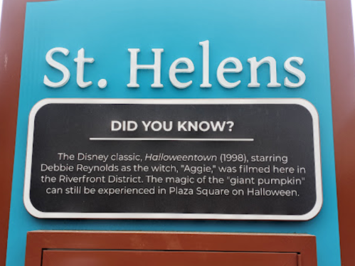 Sign about St. Helens, highlighting its connection to the film "Halloweentown" and Halloween celebrations.
