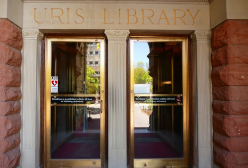 Entrance to Uris Library with double doors and a sign indicating no smoking.