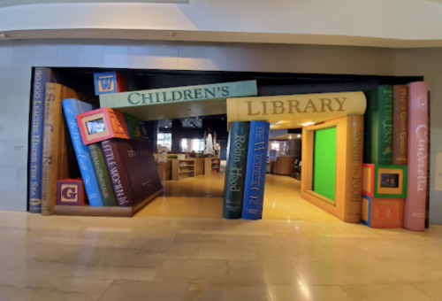 Colorful entrance to a children's library, designed to look like oversized books stacked playfully.