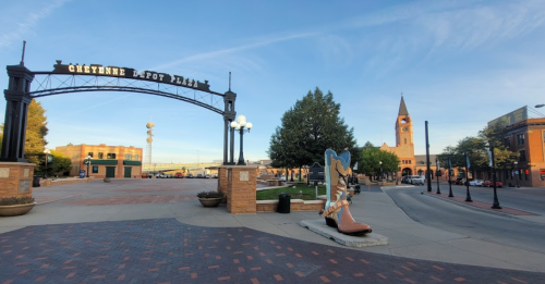 Entrance to Cheyenne Depot Plaza with a clock tower in the background and a large cowboy boot sculpture in the foreground.