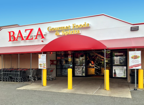 Exterior of BAZA Gourmet Foods & Spirits store, featuring a red awning and shopping carts outside.