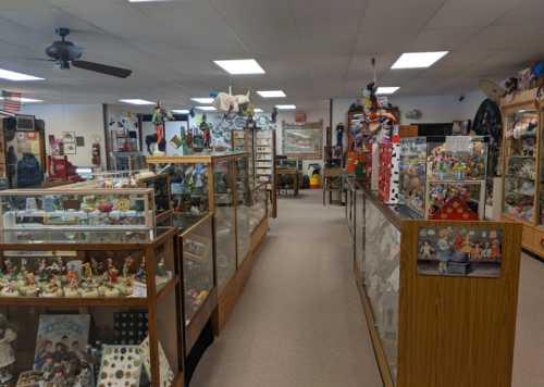 A spacious museum display filled with glass cases showcasing various collectibles and memorabilia.