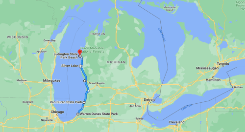 Map showing a route from Ludington State Park Beach to Silver Lake, located in Michigan, with surrounding lakes and parks.