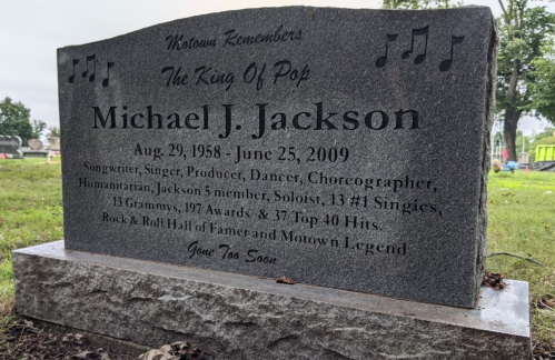 Gravestone honoring Michael J. Jackson, featuring his birth and death dates, achievements, and a musical note design.