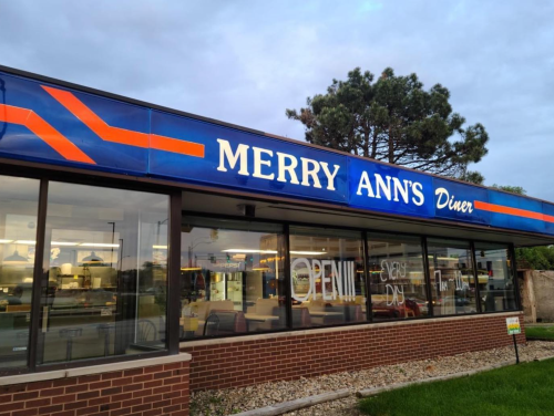 Exterior of Merry Ann's Diner with a bright sign reading "OPEN" and a modern, welcoming design.