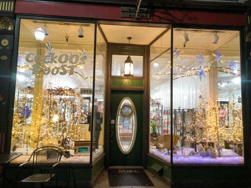 A festive storefront with holiday decorations, twinkling lights, and a welcoming entrance.