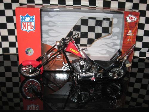 A detailed model motorcycle in a box featuring NFL branding and a checkered background.