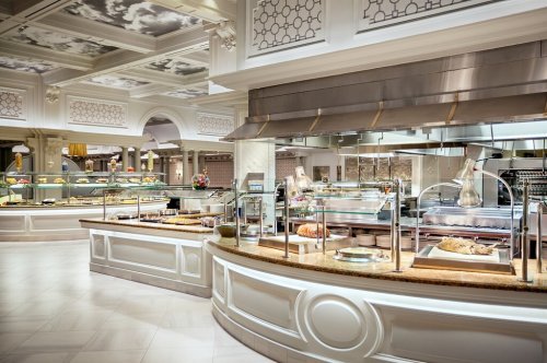 A luxurious buffet with elegant decor, featuring a variety of dishes and desserts in a spacious dining area.