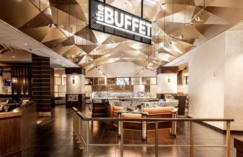 Modern buffet restaurant interior with a stylish design, featuring a prominent sign and elegant decor.